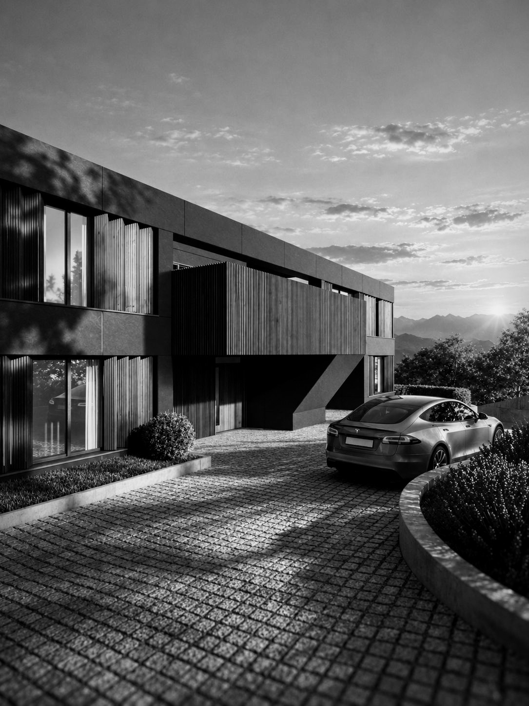 Modernes Wohnhaus mit Holzlamellen und anthrazitfarbener Fassade bei Sonnenuntergang